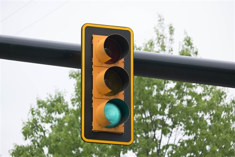 A traffic signal with a backplate on a mast arm