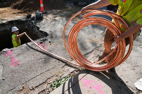 A photo of workers replacing a lead service line with a new copper line