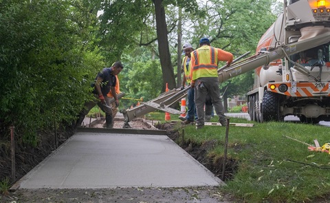 Photo of a crew pouring new sidewalk